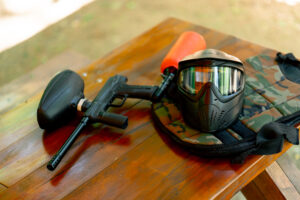 close-up of the wild nature on wooden lacquered table there is ammunition pintball gun active recreation active weekend competitions